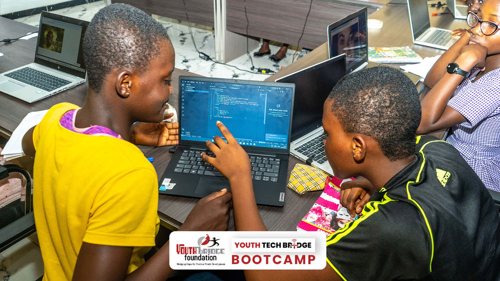 Young females from the first Youth Tech Bridge Bootcamp coding during lessons.